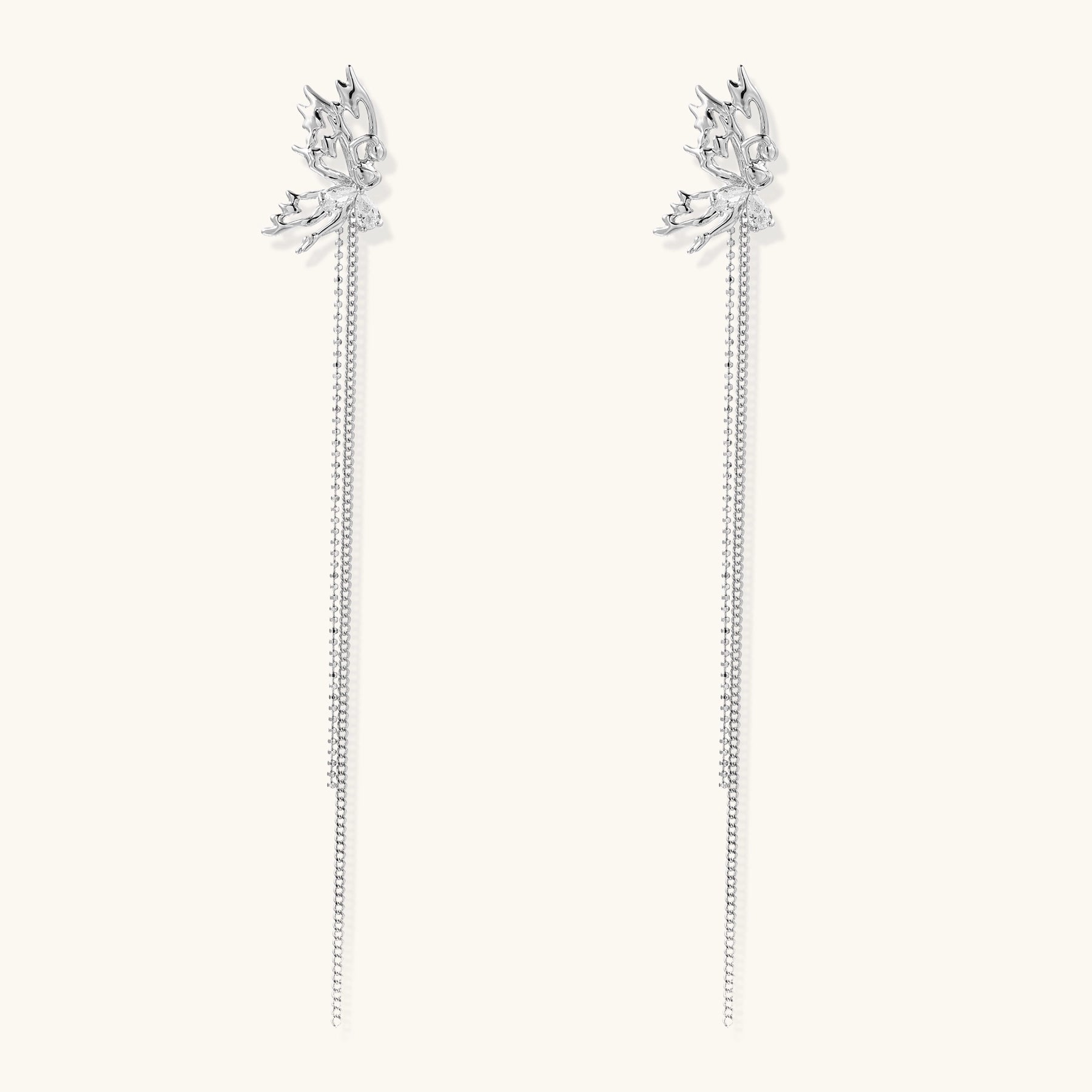 Silver-toned threader earrings featuring detailed fairy figure with wings and dual delicate chain strands, zirconia accents