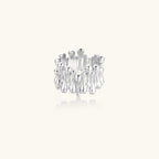 Wide band ring with sculptural wave ripples in polished white gold plated eco-brass on cream background
