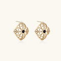 Gold filigree stud earrings with navy lapis lazuli center stone and mother-of-pearl accents in ornate quatrefoil design