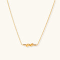 Dainty 18K gold plated necklace with infinity knot pendant on delicate chain against white background