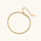 Delicate 18K gold-plated stainless steel bracelet with textured beaded chain on cream background