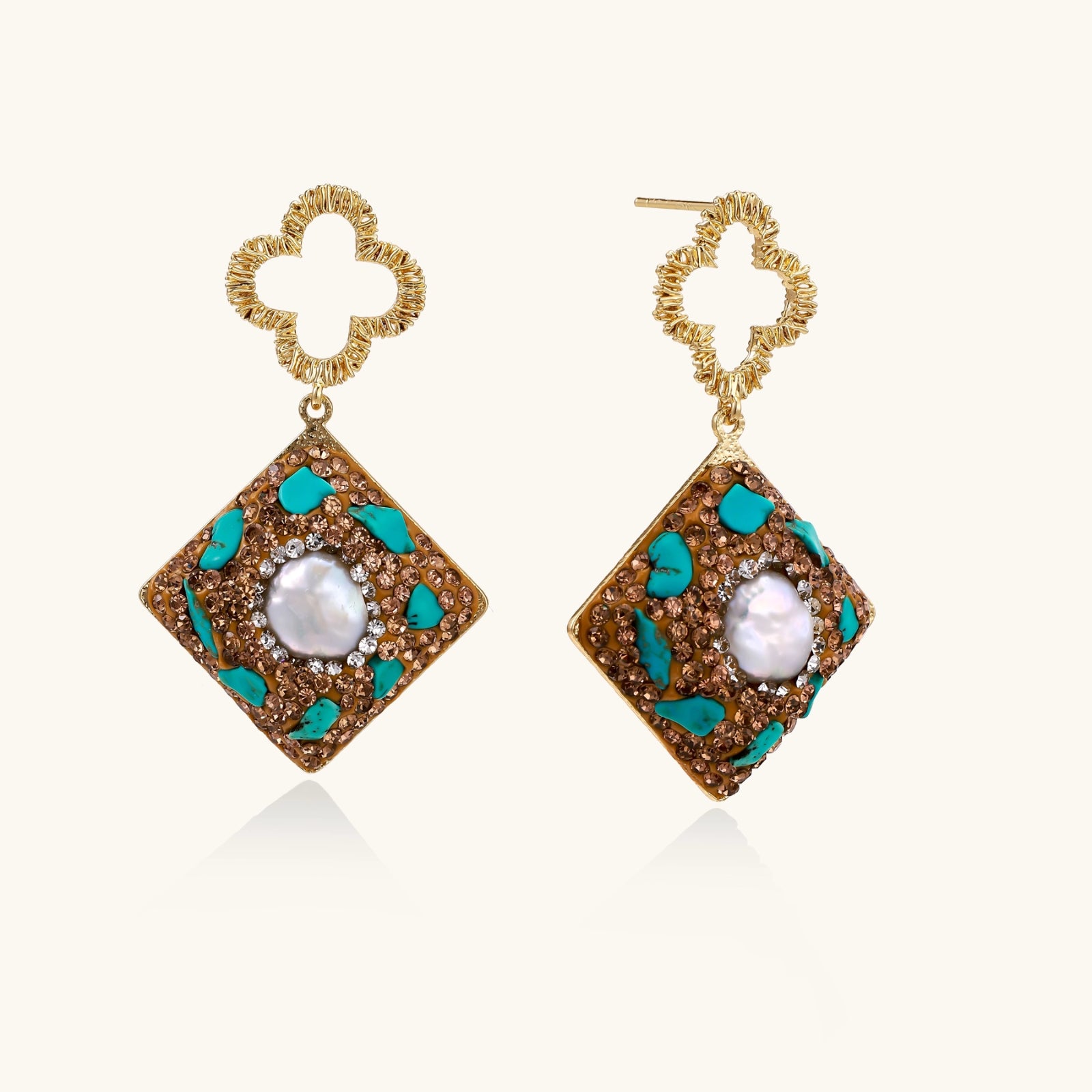 Gold-plated drop earrings with quatrefoil studs, diamond-shaped pendants featuring baroque pearls, turquoise stones, and amber crystals