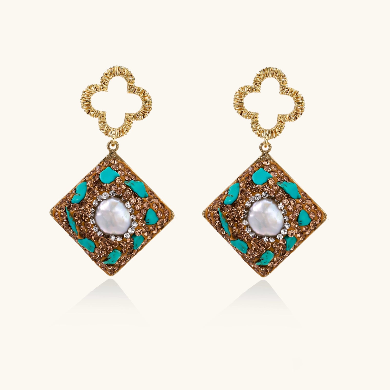 Gold-plated drop earrings with quatrefoil studs, diamond-shaped pendants featuring baroque pearls, turquoise stones, and amber crystals