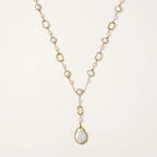 Long gold-plated necklace with alternating freshwater pearls and crystal bezels, featuring a large baroque pearl pendant