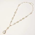 Long gold-plated necklace with alternating freshwater pearls and crystal bezels, featuring a large baroque pearl pendant