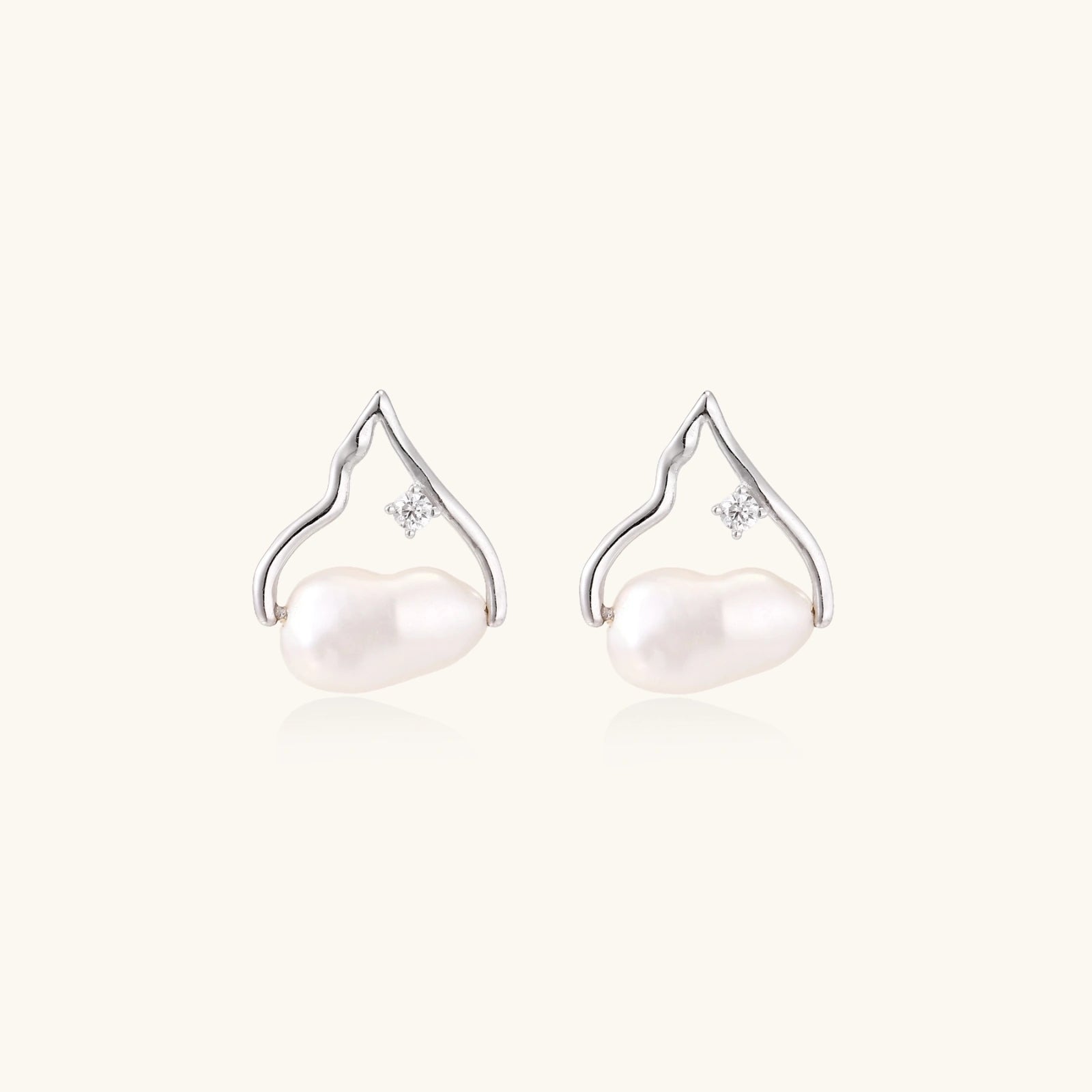 Silver mountain outline studs with baroque pearl and diamond accent on white background