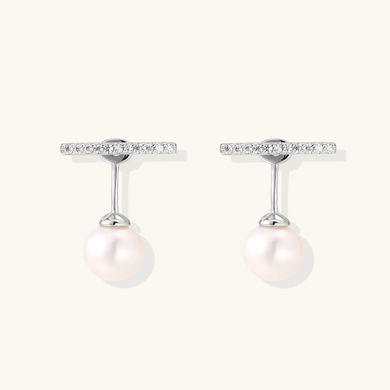 Rhodium-plated sterling silver ear jacket earrings with diamond-set horizontal bar and freshwater pearl drop