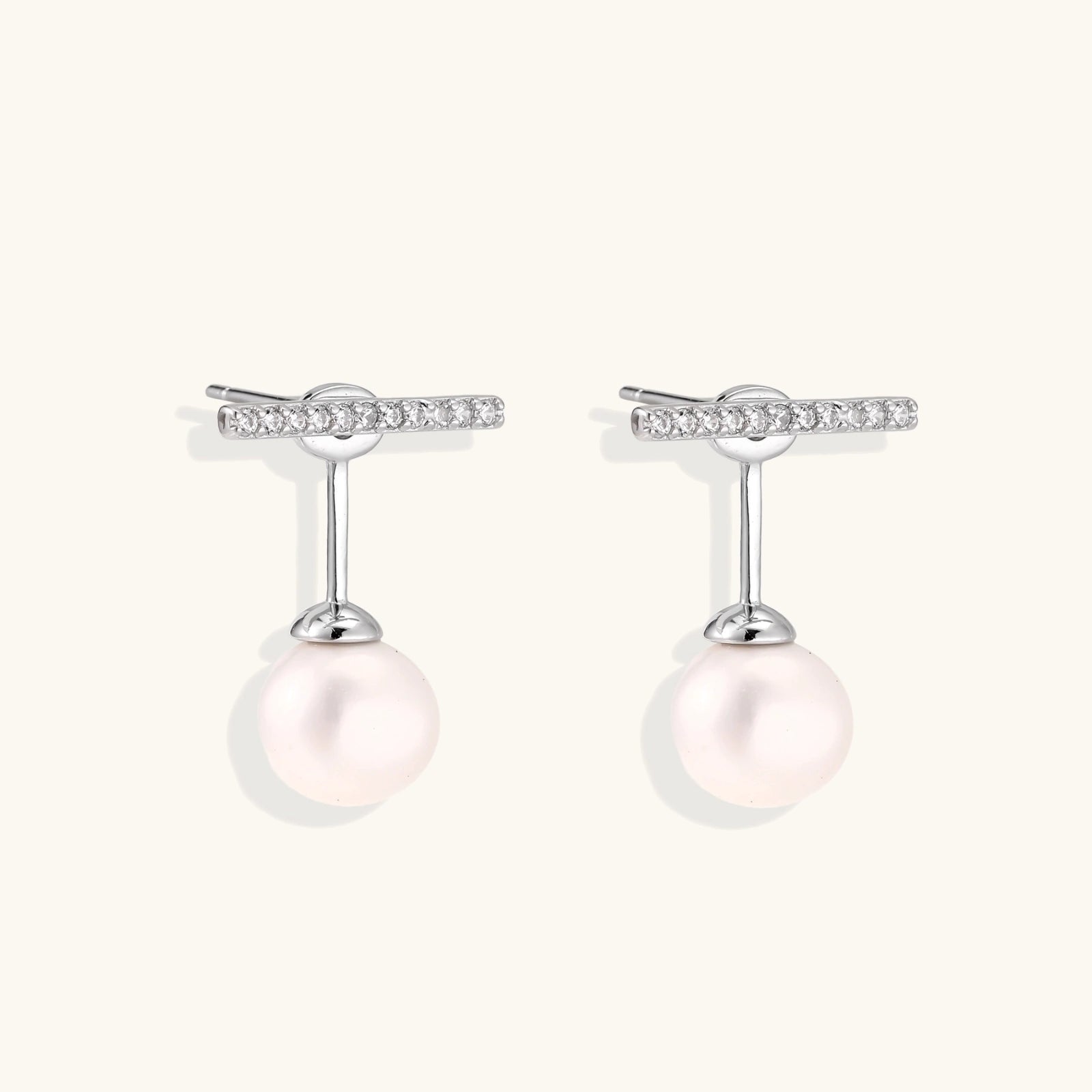Rhodium-plated sterling silver ear jacket earrings with diamond-set horizontal bar and freshwater pearl drop