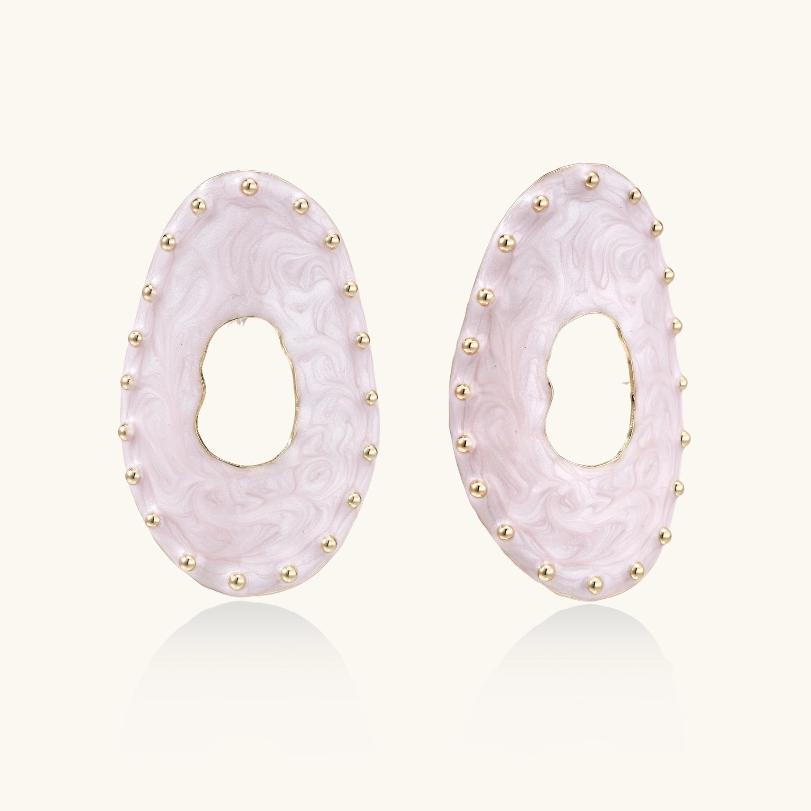 Oval lavender enamel earrings with marbled finish and gold-plated beaded border on cream background.