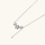 White gold plated Y-shaped necklace with three dimensional flower charms and adjustable drop pendant
