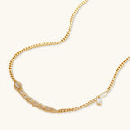 Gold-plated necklace with geometric diamond segments and matching huggie earrings featuring cubic zirconia details