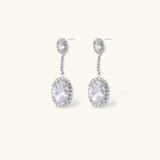 Elegant white gold plated jewelry set with oval cubic zirconia stones in halo settings, featuring Y-necklace and drop earrings.