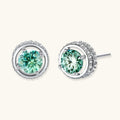 Round green moissanite stud earrings in sterling silver halo settings with brilliant sparkle on white background.
