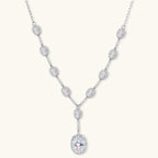 Elegant white gold plated jewelry set with oval cubic zirconia stones in halo settings, featuring Y-necklace and drop earrings.