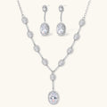 Elegant white gold plated jewelry set with oval cubic zirconia stones in halo settings, featuring Y-necklace and drop earrings.