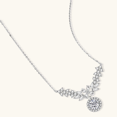 Elegant sterling silver necklace featuring intricate wing-like design with brilliant moissanite stones on neutral background.